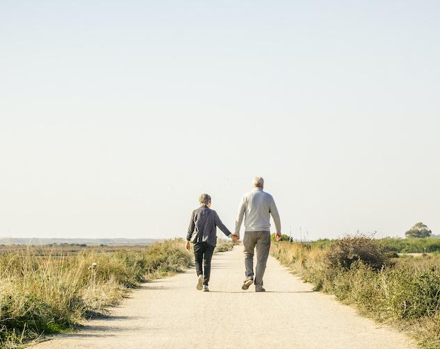 Elderly, healthy couple walking in Ria Formosa Park, Algarve, Portugal